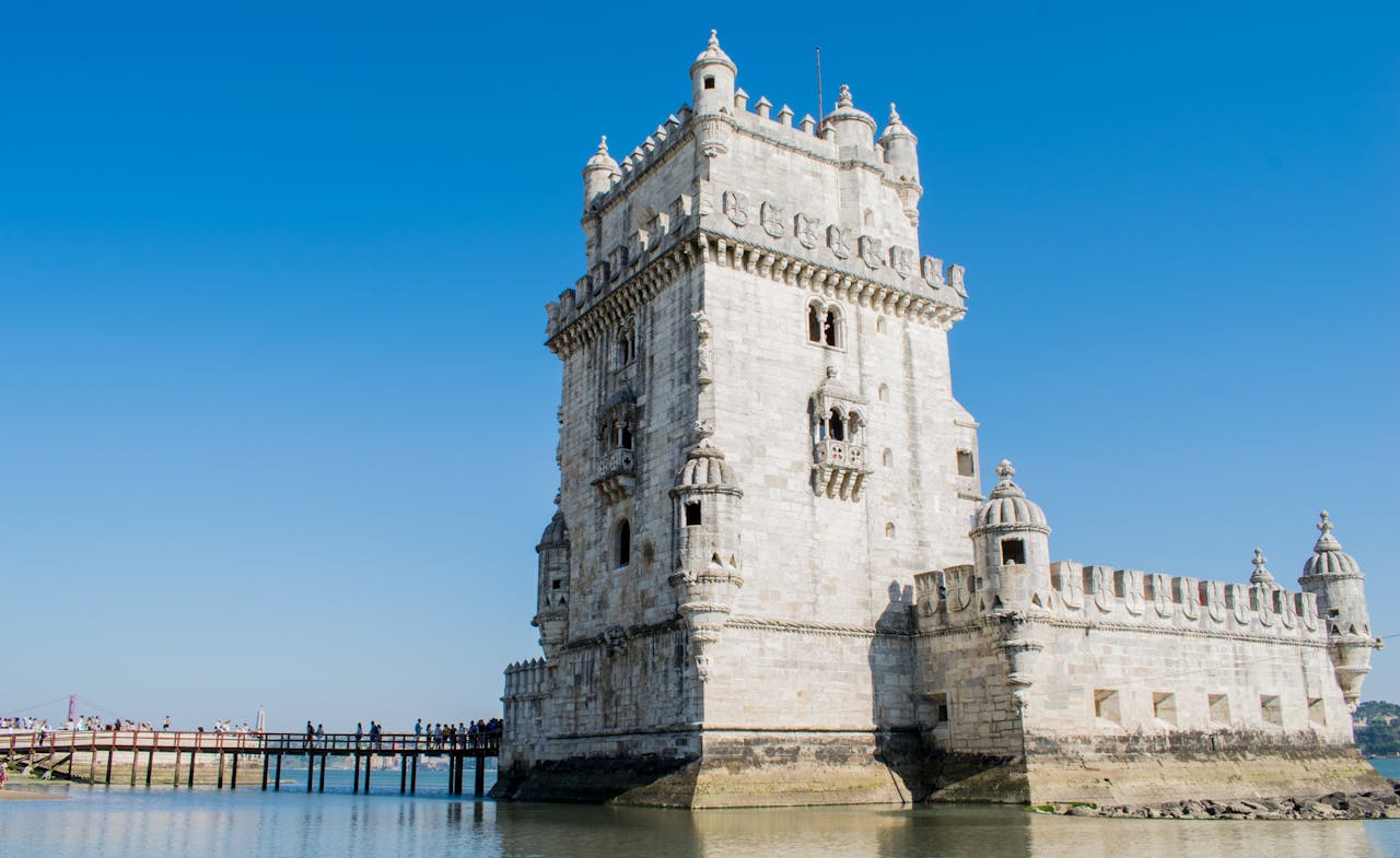 Capture of the historic Belem Tower against a clear blue sky in Lisbon, Portugal.